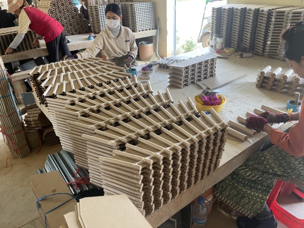 Image of people working on products in a factory